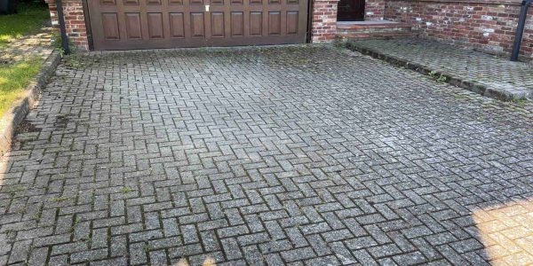 Dirty block paving driveway prior to cleaning in Suffolk