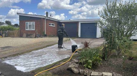 Applying treatment to driveway cleaning in Bury St Edmunds