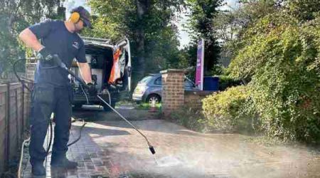 During pressure washing — block paving driveway half restored, Bury St Edmunds