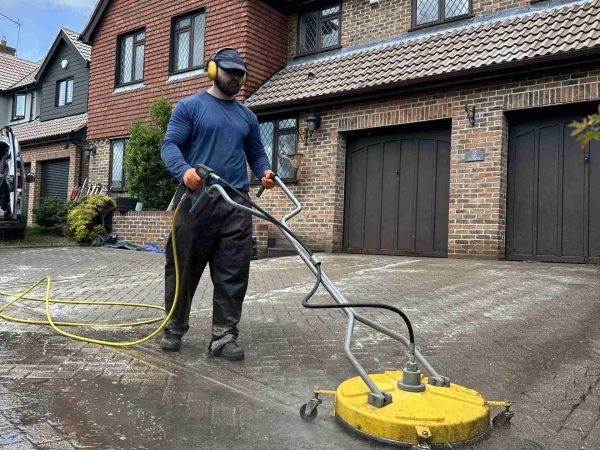 pressure washing a driveway block paving