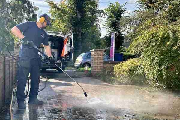 During pressure washing — block paving driveway half restored